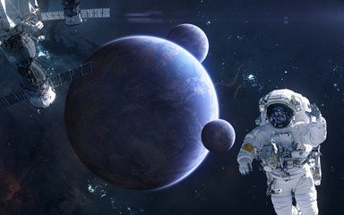 Astronaut and space station on background of deep space planets. Science fiction. Elements of this...