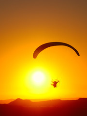 Fototapeta na wymiar Flaying to Sunset on Paramotor - In Brazilian sky.