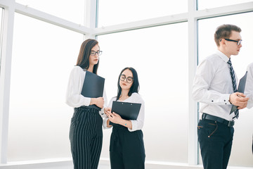 employees discussing the work plan before starting a business seminar