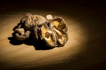 group of dried Shitake mushrooms laying on bamboo desk. food ingredient.