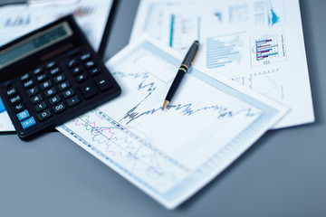 Naklejka na ściany i meble close up.pen, financial chart and calculator on the businessman's Desk