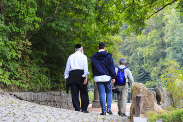 Older Hasidic Jews walk in the park during the Jewish New Year in Uman, Ukraine. Religious Jew.