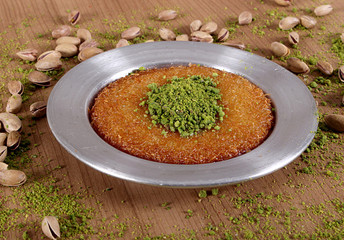 the best turkish baklava kunefe fresh on the plate is filled with green pistachio powder