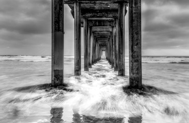 Sunset over the Pacific Ocean at Scripps Pier in La Jolla California USA black and white
