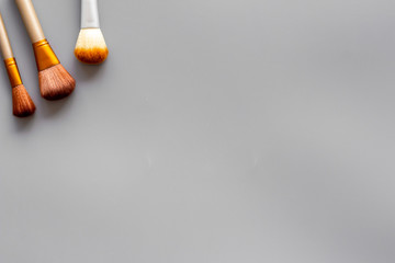 Instruments for make up with brushes on gray background top view mock up