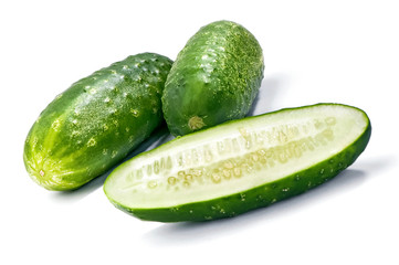 two green cucumbers and half cut along close-up isolated on white background with shadow