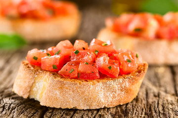 Fresh homemade tomato and basil bruschetta traditional Italian antipasto (Selective Focus, Focus on the first tomato pieces on the first bread)