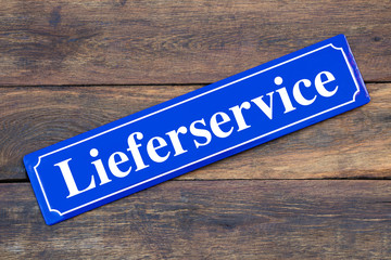 Lieferservice Schild blau auf Holz