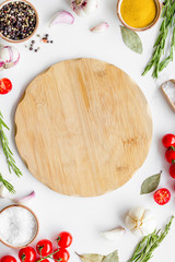Ingedients frame, cutting board and cookware for cooking on white background top view copy space