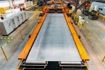 Steel sheet moving on roller conveyor, aerial view
