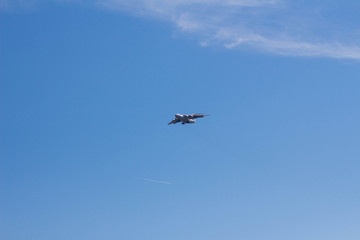 the plane flies in the sky