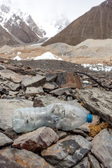 Garbage scattered over snowy mountain. Let's save the planet and recycle the excess garbage. Pollution Concept