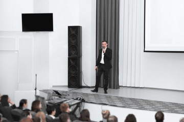 businessman man standing on stage during a press conference