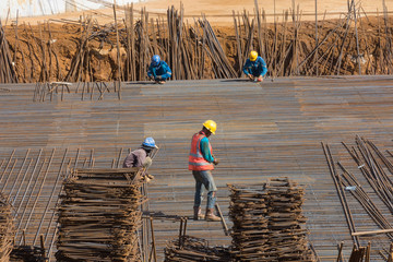 Construction workers are tying steel bars at the construction site
