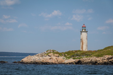Fototapeta na wymiar Franklin Island Lighthouse on a sunny summer day on Franklin Island, Muscongus Bay, Maine