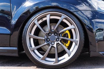 Tuned sport car wheel, close up. Low rider sport auto