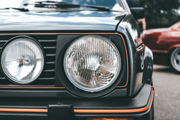 Tuned old sport car headlamp or headlight, close up