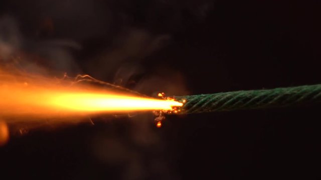 Slow motion of burning wick of bomb. Timer is ticking.