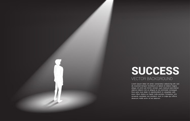 Obraz premium Silhouette of businessman standing in spotlight. business concept of mission vision and leadership