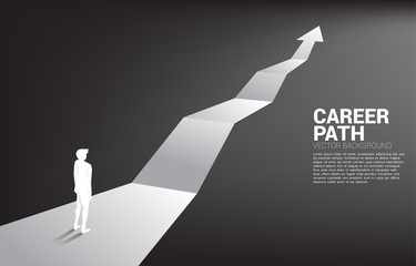 Silhouette of businessman standing on forward arrow. Concept of career path and start business