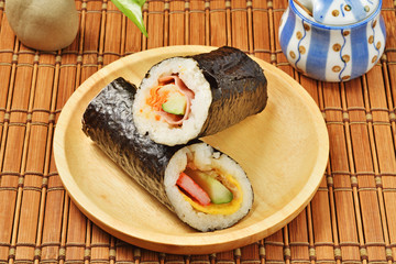 Seafood hand roll sushi on wooden plate