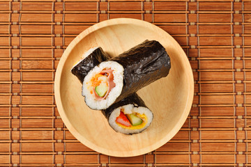 Seafood hand roll sushi on wooden plate
