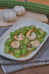 stir fried angled gourd with egg topping shrimp on dish
