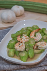 stir fried angled gourd with egg topping shrimp on dish