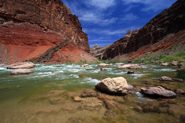 Fototapeta na wymiar Hance Rapids in Grand Canyon National Park, Arizona, with red canyon walls under a deep blue sky.