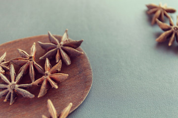Dry Star anise on a brown wooden spatula. Natural food spices and seasonings. Tasty eating....