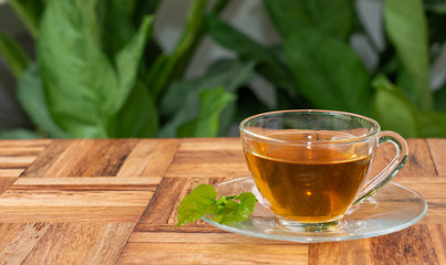 Mulberry tea leaves in a glass Placed on a wooden floor. Hot, aromatic, ready to drink