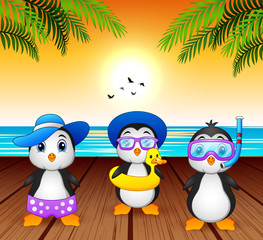 Cartoon summer penguins at the beach