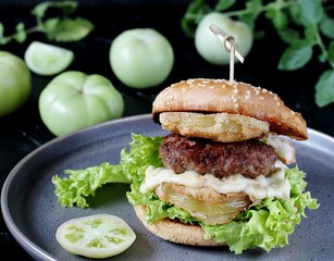 burger with fried green tomato.  american cuisine. Unripe Tomatoes Fried In A Sandwich.