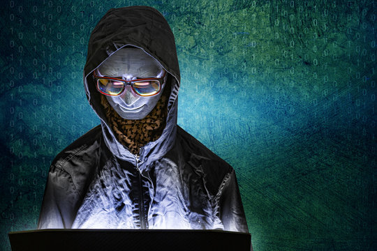 Mannequin and laptop in dark tone for cyber crime content.