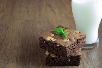 Brownie cake placed on top of the wood with basil leaves