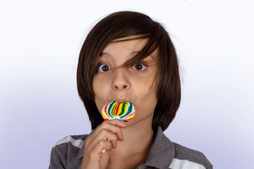 Little boy eating a lollipop.