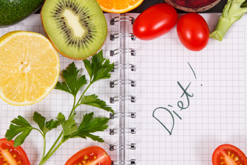 Notepad and fruits with vegetables containing vitamins and minerals, slimming and diet concept