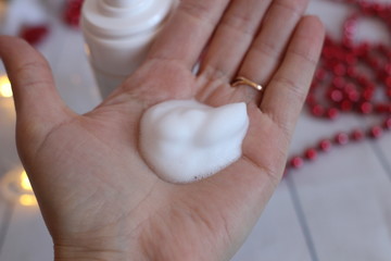 Foam for washing on a woman's hand
