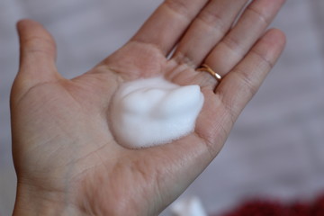 Foam for washing on a woman's hand