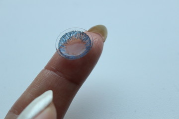Colored eye lenses on the finger