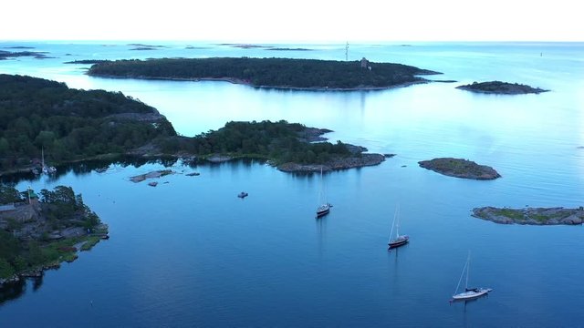 Luxury sailing yachts moored in a picturesque bay near Sandhamn, a town on the Stockholm Archipelago.