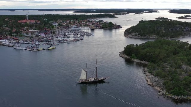 Aerial shot of a beautiful sailing ship moored near the marina of Sandhamn, Sweden at the start of the annual round Gotland boat race.