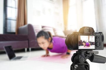 Asian women exercise workout at home, With recording making video blogger camera for their blog
