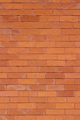Traditional vintage reddish orange brick wall texture background with weathered and worn bricks