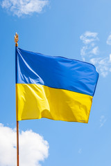 close up ukrainian national flag at blue sky background. ukrainian freedom day celebration. yellow and blue europian country emblem