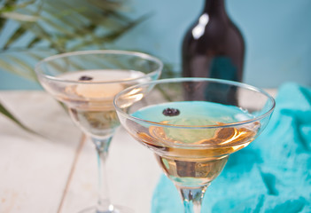 White wine in a glasses, bottle on the white wooden background. Dinner for two.