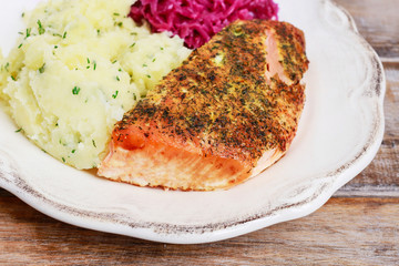 Simple dinner with fish (salmon), potatoes and vegetable salad