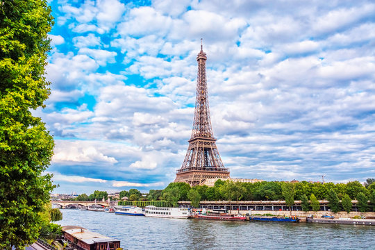 View of Eiffel Tower from the Seine river in Paris at summer evening, France