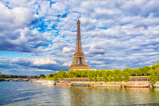 View of Eiffel Tower from the Seine river in Paris at summer evening, France