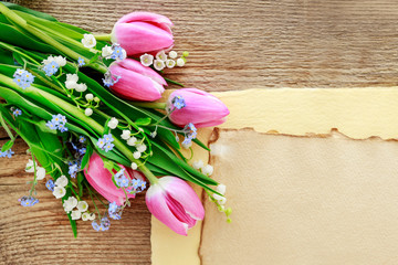 Bouquet of pink tulips, lily of the valley and forget me not flowers.